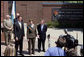 Mrs. Laura Bush joined by, from left, U.S.Rep. Mike Turner and U.S. Sen. Mike DeWine talk to the press after touring Wright-Dunbar Village in Dayton, Ohio, Wednesday, August 16, 2006. The Village is a Preserve America neighborhood that is home to the historic sites where the Wright brothers worked on the inventions that led to flight and Paul Laurence Dunbar printed his newspaper. White House photo by Shealah Craighead