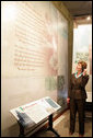 Mrs. Laura Bush listens to a reading of a Paul Laurence Dunbar poem during a tour of the Wright-Dunbar Village, a Preserve America neighborhood, in Dayton, Ohio, Wednesday, August 16, 2006. Paul Laurence Dunbar published a newspaper for the African American community, which the Wright Brothers printed for him in their printing shop. White House photo by Shealah Craighead