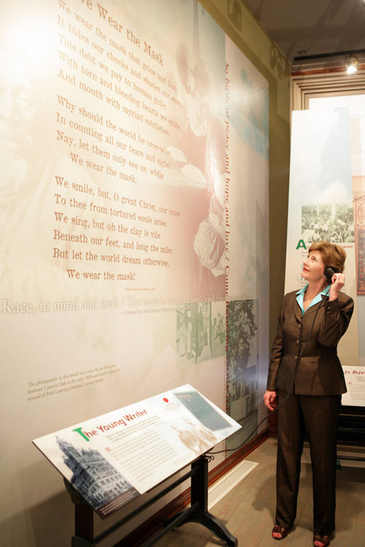 Mrs. Laura Bush listens to a reading of a Paul Laurence Dunbar poem during a tour of the Wright-Dunbar Village, a Preserve America neighborhood, in Dayton, Ohio, Wednesday, August 16, 2006. Paul Laurence Dunbar published a newspaper for the African American community, which the Wright Brothers printed for him in their printing shop. White House photo by Shealah Craighead