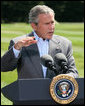 President George W. Bush gestures as he answers a reporter's question Friday, Aug. 18, 2006 in Camp David, Md., following a meeting with his economic advisors. White House photo by Eric Draper