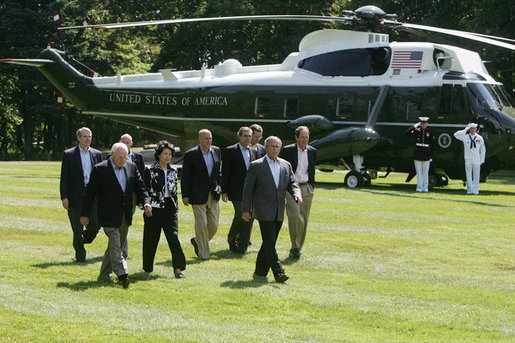 President George W. Bush leads his economic advisors past Marine One on the way to speak with reporters Friday, Aug. 18, 2006 in Camp David, Md., following their meeting on the nation’s economy. President Bush said the foundation of our economy is strong and is maintaining solid growth. White House photo by David Bohrer