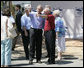 President George W. Bush is joined by Biloxi, Miss. Mayor A.J. Holloway, right, Monday, Aug. 28, 2006, during President Bush’s walking tour in the same Biloxi neighborhood he visited following Hurricane Katrina in September 2005. The tour allowed President Bush the opportunity to assess the progress of the area’s recovery and rebuilding efforts following the devastating hurricane. White House photo by Eric Draper