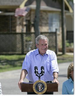 President George W. Bush smiles as he addresses his remarks to residents and state community leaders Monday, Aug. 28, 2006, following his walking tour through the Biloxi, Miss., neighborhood he visited following Hurricane Katrina in September 2005. The tour allowed President Bush the opportunity to assess the progress of the area’s recovery and rebuilding efforts a year after the devastating hurricane. White House photo by Eric Draper