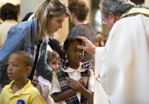 A young girl receives a blessing during a memorial Mass attended by President George W. Bush and Laura Bush at St. Louis Cathedral in New Orleans, Tuesday morning, Aug. 29, 2006, to commemorate the one- year anniversary of Hurricane Katrina. White House photo by Eric Draper