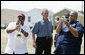 President George W. Bush is greeted by the New Birth Brass Band as he arrives Tuesday, Aug. 29, 2006, at the Habitat for Humanity's Musician's Village in New Orleans' 9th Ward, where he had lunch with volunteers and local residents. The Village will consist of 81 Habitat-constructed homes for displaced New Orleans musicians. White House photo by Eric Draper