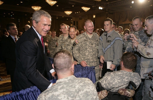 President George W. Bush is greeted by military personnel following his address on the global war on terror at the Military Officers Association of America meeting Tuesday, Sept. 5, 2006, at the Capital Hilton Hotel in Washington. President Bush spoke about the U.S. and allies strategy for combating terrorism saying "we're confronting them before they gain the capacity to inflict unspeakable damage on the world, and we're confronting their hateful ideology before it fully takes root." White House photo by Kimberlee Hewitt