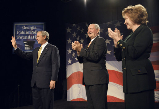 President George W. Bush acknowledges the Atlanta audience as he arrives on stage Thursday, Sept. 7, 2006, at the Cobb Galleria Centre to deliver his remarks on the global war on terror to the Georgia Public Policy Foundation. Joining the applause for the President are Georgia's Gov. Sonny Perdue and Dr. Brenda Fitzgerald, Chairman, Board of Governors, the Georgia Public Policy Foundation. White House photo by Eric Draper