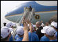 President George W. Bush waves to Georgia Governor Sonny Perdue and the Columbus Northern Little League Team at Dobbins Air Reserve Base in Marietta, Ga., Thursday, Sept. 7, 2006. The team defeated the Kawaguchi Little League of Japan, 2 to 1, to win the 2006 Little League Baseball World Series Championship on August 28 in Williamsport, Pa. It is the second consecutive year that an American team has won the world series title. White House photo by Eric Draper