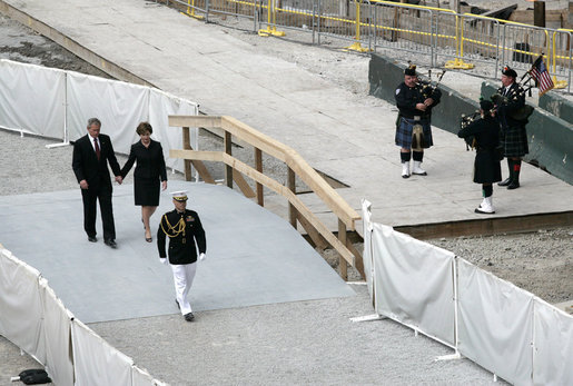 After laying a wreath in the north tower reflecting pool, President George W. Bush and Laura Bush walk through the World Trade Center site to lay a second wreath in the south tower reflecting pool to commemorate the fifth anniversary of the September 11th terrorist attacks in New York City Sunday, September 10, 2006. White House photo by Eric Draper