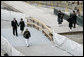 After laying a wreath in the north tower reflecting pool, President George W. Bush and Laura Bush walk through the World Trade Center site to lay a second wreath in the south tower reflecting pool to commemorate the fifth anniversary of the September 11th terrorist attacks in New York City Sunday, September 10, 2006. White House photo by Eric Draper