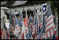 During their visit to Ground Zero, President George W. Bush and Laura Bush look at a memorial created from some of the objects visitors have brought to the site in New York City Sunday, September 10, 2006. White House photo by Eric Draper