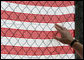 A visitor at the fence overlooking Ground Zero touches an American flag printed with names of those who were killed during the September 11th terrorist attacks Sunday, September 10, 2006. President and Mrs. Bush also visited the site Sunday to mark the fifth anniversary of the attacks. White House photo by Kimberlee Hewitt