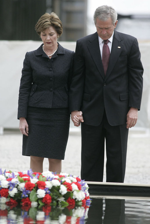 President George W. Bush and Laura Bush stand in silence after laying a wreath in the north reflecting pool at Ground Zero September 10, 2006, in commemoration of the fifth anniversary of the terrorist attacks of September 11, 2001, on the World Trade Center in New York City. White House photo by Kimberlee Hewitt