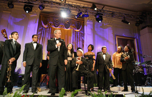 President George W. Bush stands with performers on stage in the East Room Thursday night, Sept. 14, 2006, as he offers closing remarks to guests at the Thelonious Monk Institute of Jazz dinner at the White House. White House photo by Shealah Craighead