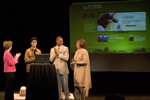 Watching the launch of a new Pakistani cultural and arts website, Mrs. Laura Bush stands with student Shaan Mihza of Eleanor Roosevelt High School, left; student Timothy Brown of Chantilly High School, and Mrs.Sehba Musharraf, wife of Pakistan's President Pervez Musharraf, Thursday, Sept. 21, 2006, at The John F. Kennedy Center for the Performing Arts in Washington, D.C. The website is created by the Pakistan National Council the Arts and The Kennedy Center and is called, "Gift of the Indus: The Arts and Culture of Pakistan." White House photo by Shealah Craighead