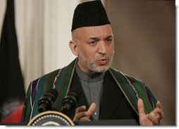 President Hamid Karzai, of the Islamic Republic of Afghanistan, responds to a reporter's question Tuesday, Sept. 26, 2006, during a joint availability with President George W. Bush in the East Room of the White House. Said President Karzai, "I think it is very important that we have more dedication and more intense work with sincerity, all of us, to get rid of the problems we have around the world."  White House photo by Paul Morse