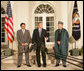 President George W. Bush stands with President Pervez Musharraf of the Islamic Republic of Pakistan, left, and President Hamid Karzai of the Islamic Republic of Afghanistan, Wednesday evening, Sept. 27, 2006, in the Rose Garden at the White House speaking to reporters prior to the three leaders attending a private dinner. White House photo by David Bohrer