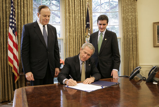 President George W. Bush signs S. 3850, The Credit Rating Agency Reform Act of 2006, in the Oval Office Friday, Sept. 29, 2006. Standing with President Bush are bill sponsors Senator Richard Shelby, R-Ala., left, and Representative Mike Fitzpatrick, R-Pa. The legislation removes the Securities and Exchange Commission from the process of approving certain rating agencies as nationally recognized statistical rating organizations. White House photo by Eric Draper