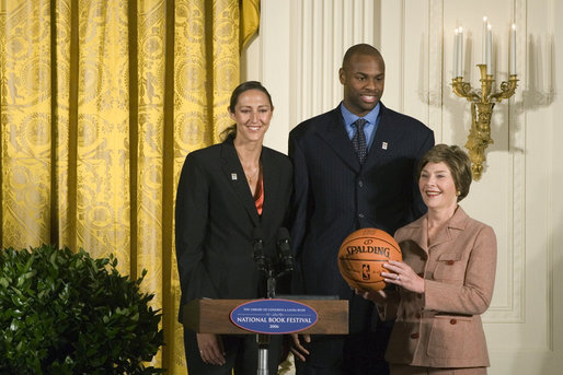 Mrs. Laura Bush stands with Ruth Riley, Detroit Shock WNBA player, left, and Brendan Haywood, Washington Wizards NBA player, after receiving the NBA Cares award Saturday, September, 30, 2006, during the National Book Festival opening ceremony in the East Room of the White House. White House photo by Shealah Craighead