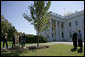 President George W. Bush and Laura Bush take part in the planting of three elm trees on the north grounds of the White House Monday, Oct. 2, 2006. The trees, cultivated by the National Park Service, replace trees recently lost to age, winds and Dutch elm disease. The new trees were grown to be resistant to the disease. White House photo by Eric Draper