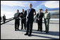 President George W. Bush stands with California forestry officials as he delivers a statement Tuesday, Oct. 3, 2006, at Los Angeles International Airport regarding the state's wildfires. The President told the crowd, "I really want to thank the brave firefighters who risk their lives on a daily basis to contain the fires." White House photo by Eric Draper