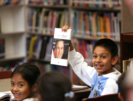 A student holds up a book about President George W. Bush during the President's visit to the elementary school named after him in Stockton, Calif., Tuesday, Oct. 3, 2006. White House photo by Eric Draper