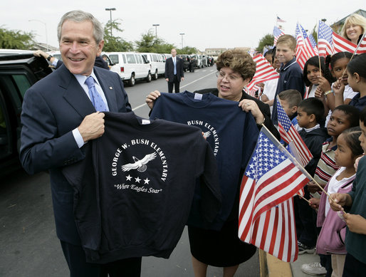 President George W. Bush holds up a T-shirt from George W. Bush Elementary School while visiting with students in Stockton, Calif., Tuesday, Oct. 3, 2006. White House photo by Eric Draper