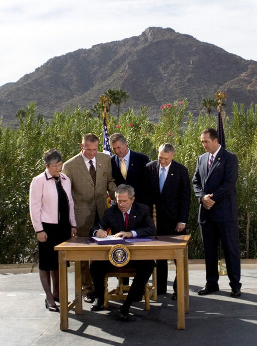 President George W. Bush is joined by Arizona legislators as he signs H.R. 5441, Department of Homeland Security Appropriations Act for fiscal year 2007, Wednesday, Oct. 4, 2006, against a backdrop of Camelback Mountain in Scottsdale. From left are: Arizona Gov. Janet Napolitano, Rep. J.D. Hayworth, Rep. Rick Renzi, Sen. Jon Kyl, R-Ariz., and Rep. Trent Franks. White House photo by Eric Draper