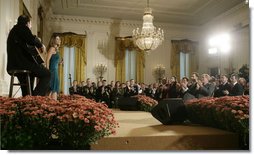 President George W. Bush is joined by Spain's Crown Prince Felipe de Borbon y Grecia, seated left, as they applaud the performance of singer Ana Cristina and guitarist Marco Linares, Friday, Oct. 6, 2006, in the East Room of the White House, in celebration of Hispanic Heritage Month. White House photo by Kimberlee Hewitt