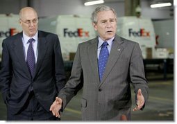 President George W. Bush addresses his remarks on the economy following his meeting with small-to-medium-sized business leaders Friday, Oct. 6, 2006, at the FedEx Express DCA Facility in Washington, D.C., during a roundtable discussion on job growth and the economy. U.S. Secretary of the Treasury Henry Paulson, is seen background-left.  White House photo by Kimberlee Hewitt