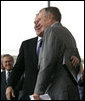 President George W. Bush hugs his father, Former President George H. W. Bush, after delivering remarks at the Christening Ceremony for the George H.W. Bush (CVN 77) in Newport News, Virginia, Saturday, Oct. 7, 2006. White House photo by Eric Draper