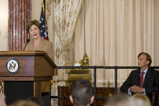 Newly sworn-in Ambassador Mark Dybul, Coordinator of the Office of the US Global AIDS, looks at Mrs. Laura Bush as she speaks to an audience of Ambassadors to the United States, government officials, representatives from the public health sector and Non-Governmental Organizations Tuesday, October 10, 2006, during the swearing-in ceremony of Ambassador Mark Dybul in the Benjamin Franklin Room at the U.S. Department of State in Washington, D.C. Ambassador Dybul will coordinate and oversee the U.S. global response to HIV/AIDS, and lead implementations of the U.S. President's Emergency Plan for AIDS Relief (Emergency Plan/PEPFAR), the largest commitment ever by any nation for an international health initiative dedicated to a single disease. White House photo by Shealah Craighead