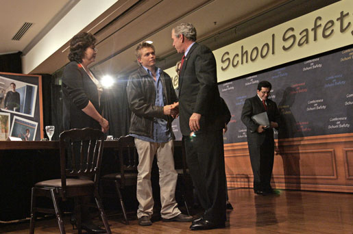 President George W. Bush talks with former Columbine High School student Craig Scott during a panel discussion on school safety at the National 4-H Conference Center in Chevy Chase, Md., Tuesday, Oct. 10, 2006. "All of us in this country want our classrooms to be gentle places of learning, places where people not only learn the basics -- basic skills necessary to become productive citizens, but learn to relate to one another," said President Bush. "And our parents I know want to be able send their child or children to schools that are safe places." White House photo by Kimberlee Hewitt