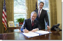 With Sen. Bill Frist (R-Tenn.) looking on, President George W. Bush signs into law S. 3728, the North Korea Nonproliferation Act of 2006, Friday, Oct. 13, 2006, in the Oval Office.  White House photo by Eric Draper