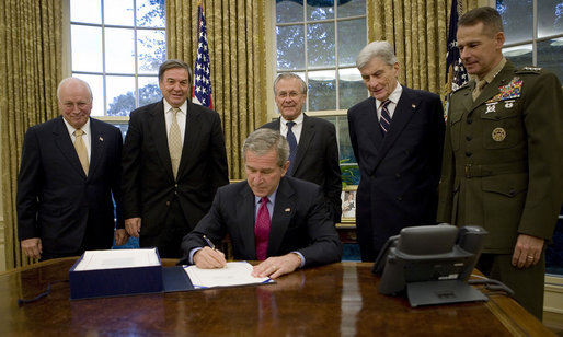 President George W. Bush signs into law H.R. 5122, the John Warner National Defense Authorization Act for Fiscal Year 2007, Tuesday, Oct. 17, 2006, in the Oval Office. Joining him are from left: Vice President Dick Cheney, Rep. Duncan Hunter of California, Secretary of Defense Donald Rumsfeld, Sen. John Warner of Virginia, and General Peter Pace, Chairman, Joint Chiefs of Staff. White House photo by Eric Draper