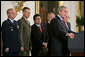 President George W. Bush speaks during the signing of S. 3930, the Military Commissions Act of 2006, Tuesday, Oct. 17, 2006, in the East Room. "It is a rare occasion when a President can sign a bill he knows will save American lives. I have that privilege this morning," said President Bush. Pictured in the background are, from left, Deputy Director of National Intelligence Michael Hayden; General Peter Pace, Chairman of the Joint Chiefs of Staff; Attorney General Alberto Gonzales; Defense Secretary Donald Rumsfeld and Vice President Dick Cheney. White House photo by Paul Morse