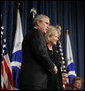 President George W. Bush congratulates Mary Peters following her ceremonial swearing-in as the 15th U.S. Secretary of Transportation, Tuesday, Oct. 17, 2006 at the Department of Transportation in Washington, D.C. White House photo by Paul Morse