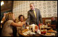 President George W. Bush shakes the hand of a patron at Stamey's barbeque in Greensboro, N.C., during a lunch with community leaders Wednesday, Oct. 18, 2006.  White House photo by Paul Morse