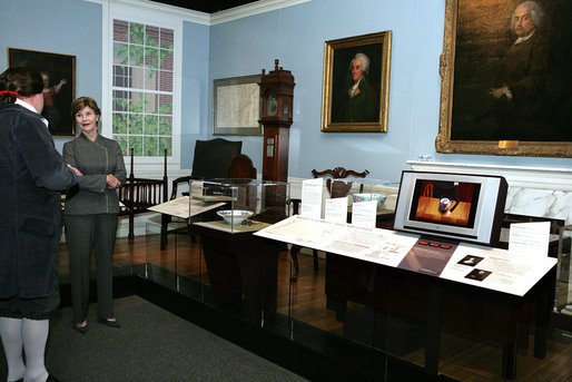 Mrs. Laura Bush listens to David Temple, actor portraying Benjamin Franklin, Wednesday, October 18, 2006, as he guides her through the Benjamin Franklin: In Search of a Better World Exhibit, at the Houston Museum of Natural Science in Houston, Texas. The exhibition, a blend of art, history, science, and material culture, features Franklin's original possessions, including many items never publicly displayed, iconic works of art and rare documents. It also features interactive devices that enable visitors to explore Franklin's eighteenth-century world using twenty-first-century technology. White House photo by Shealah Craighead