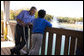 President George W. Bush shares a quiet moment with 10-year-old Hank Grissom Wednesday Oct. 18, 2006, at the Victory Junction Gang Camp in Randleman, N.C. The Charlotte, N.C. youngster, who has Spina Bifida, attends the camp, which was founded in 2004 by Kyle and Pattie Petty in honor of their son, Adam, to help enrich the lives of kids with chronic medical conditions or serious illnesses. White House photo by Paul Morse