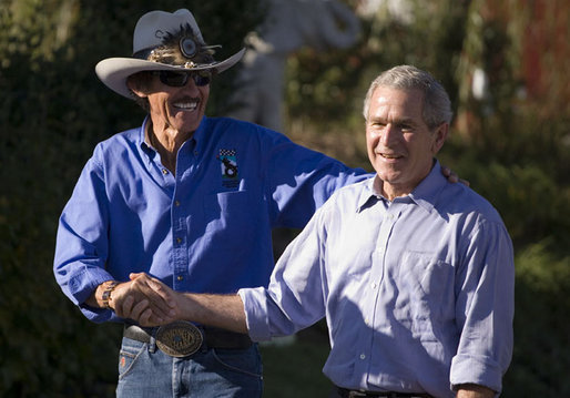 President George W. Bush enjoys a moment with NASCAR racing champion Richard Petty during a visit Wednesday, Oct. 18, 2006, to the Victory Junction Gang Camp, Inc., in Randleman, N.C. The center was founded by Petty's son, Kyle, and Kyle's wife, Pattie, in memory of their son, Adam, a fourth-generation NASCAR driver killed during practice in 2000. White House photo by Paul Morse