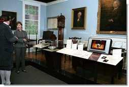 Mrs. Laura Bush listens to David Temple, actor portraying Benjamin Franklin, Wednesday, October 18, 2006, as he guides her through the Benjamin Franklin: In Search of a Better World Exhibit, at the Houston Museum of Natural Science in Houston, Texas. The exhibition, a blend of art, history, science, and material culture, features Franklin's original possessions, including many items never publicly displayed, iconic works of art and rare documents. It also features interactive devices that enable visitors to explore Franklin's eighteenth-century world using twenty-first-century technology. White House photo by Shealah Craighead