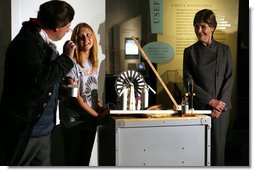 Mrs. Laura Bush watches as David Temple, actor portraying Benjamin Franklin, performs a demonstration related to static electricity at the Houston Museum of Natural Science, Wednesday, October 18, 2006, with the help of a 6th grade student from the Baines Middle School in Houston, TX.  White House photo by Shealah Craighead