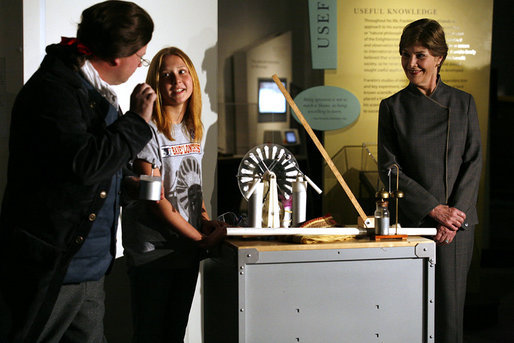 Mrs. Laura Bush watches as David Temple, actor portraying Benjamin Franklin, performs a demonstration related to static electricity at the Houston Museum of Natural Science, Wednesday, October 18, 2006, with the help of a 6th grade student from the Baines Middle School in Houston, TX. White House photo by Shealah Craighead