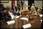 President George W. Bush listens to Bailey Reese, 10, founder of Hero Hugs, which sends care packages to our troops serving overseas, during a meeting with organizations that support the U.S. Military in Iraq and Afghanistan in the Roosevelt Room, Friday, October 20, 2006. White House photo by Eric Draper