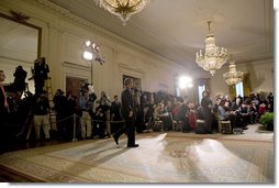 President George W. Bush walks into the East Room for a press conference in Wednesday, Oct. 25, 2006. "Our security at home depends on ensuring that Iraq is an ally in the war on terror and does not become a terrorist haven like Afghanistan under the Taliban," said President Bush. White House photo by Paul Morse