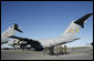 President George W. Bush walks past C-17 aircraft before addressing military personnel and their families at Charleston Air Force Base in Charleston, South Carolina on Saturday, October 28, 2006. White House photo by Paul Morse