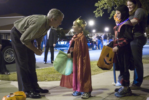 President George W. Bush shares a moment with a king during a Halloween night stop Tuesday, Oct. 31, 2006, at a housing development on base at Robins Air Force Base, Ga. White House photo by Paul Morse