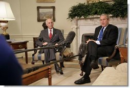 President George W. Bush and Andrew Natsios, Presidential Special Envoy for Sudan, meet with the press in the Oval Office Tuesday, Oct. 31, 2006. "The situation in Darfur is on our minds," said the President. "The people who have suffered there need to know that the United States will work with others to help solve the problem." White House photo by Kimberlee Hewitt