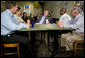 President George W. Bush talks with small business owners before delivering a live Radio Address from the Mile High Coffee shop in Englewood, Colorado, Saturday, Nov. 4, 2006. White House photo by Eric Draper